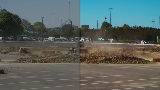 A utility vehicle kicking up dust on a dirt track: the left half pale, the right half with a blue sky and brown dirt.